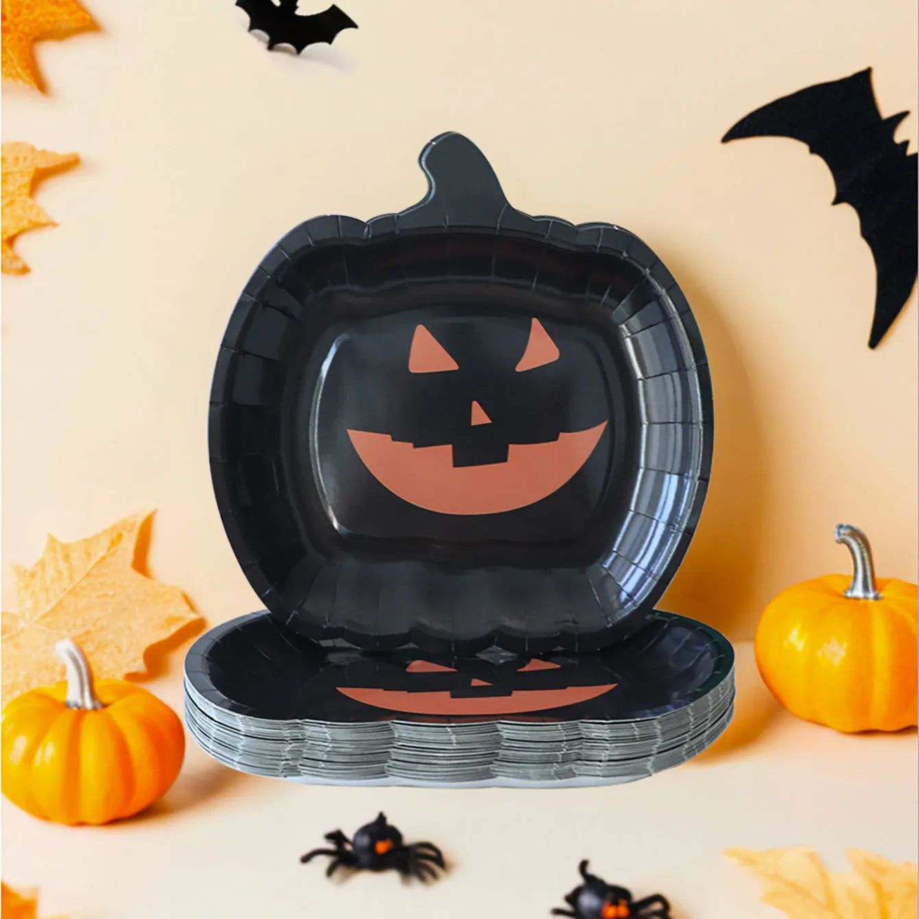 Black Halloween paper plate with pumpkin design, 9 inches in diameter.