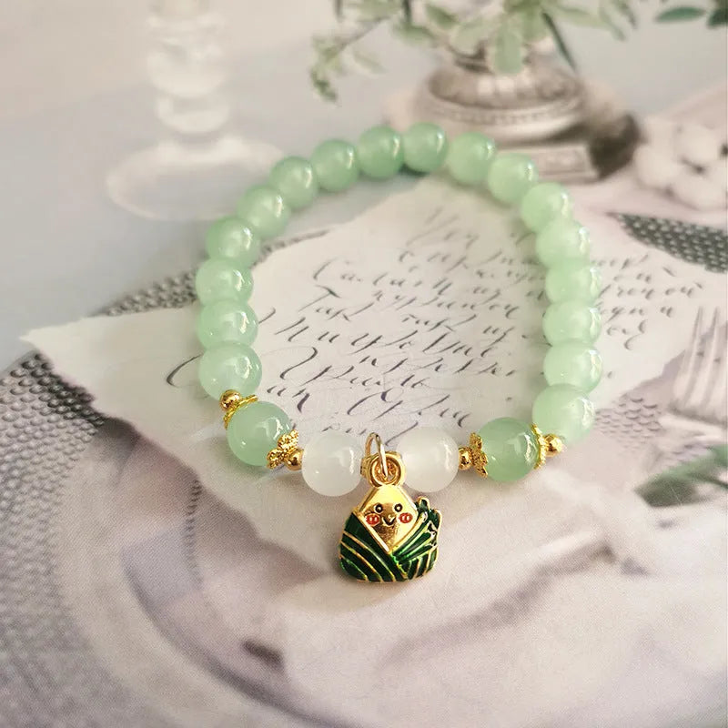 Chinese style glass bead bracelet with bamboo leaf design and manual craftsmanship details.
