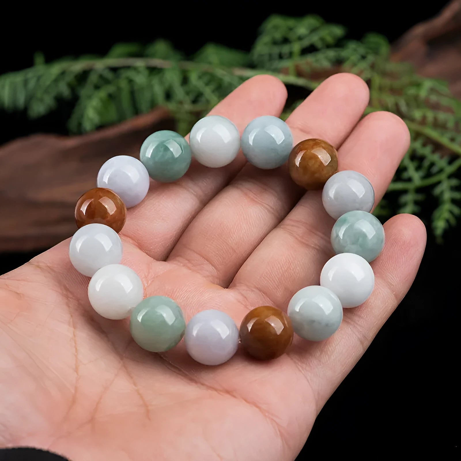 Women's jade bracelet with green, lavender and white beads showing certificate