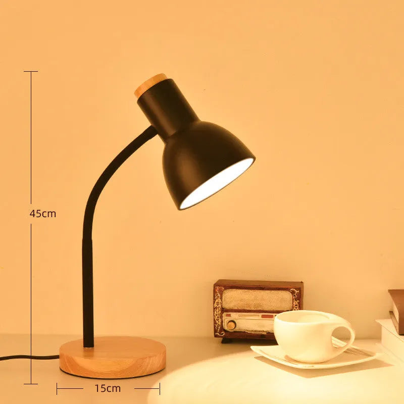 A modern LED table lamp with a push button dimmer switch on its base.