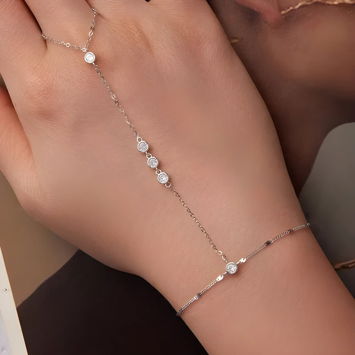 S925 sterling silver tassel bracelet with integrated ring and chain, shown in silver or gold electroplated finish