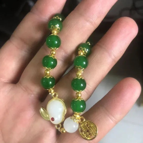 Chinese style glass bead bracelet with bamboo leaf design and manual craftsmanship details.