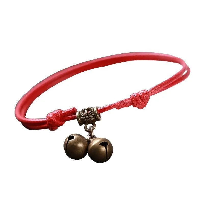 Adjustable nylon dog collar with a brass bell on a black rope, showing the fitting and casual style.