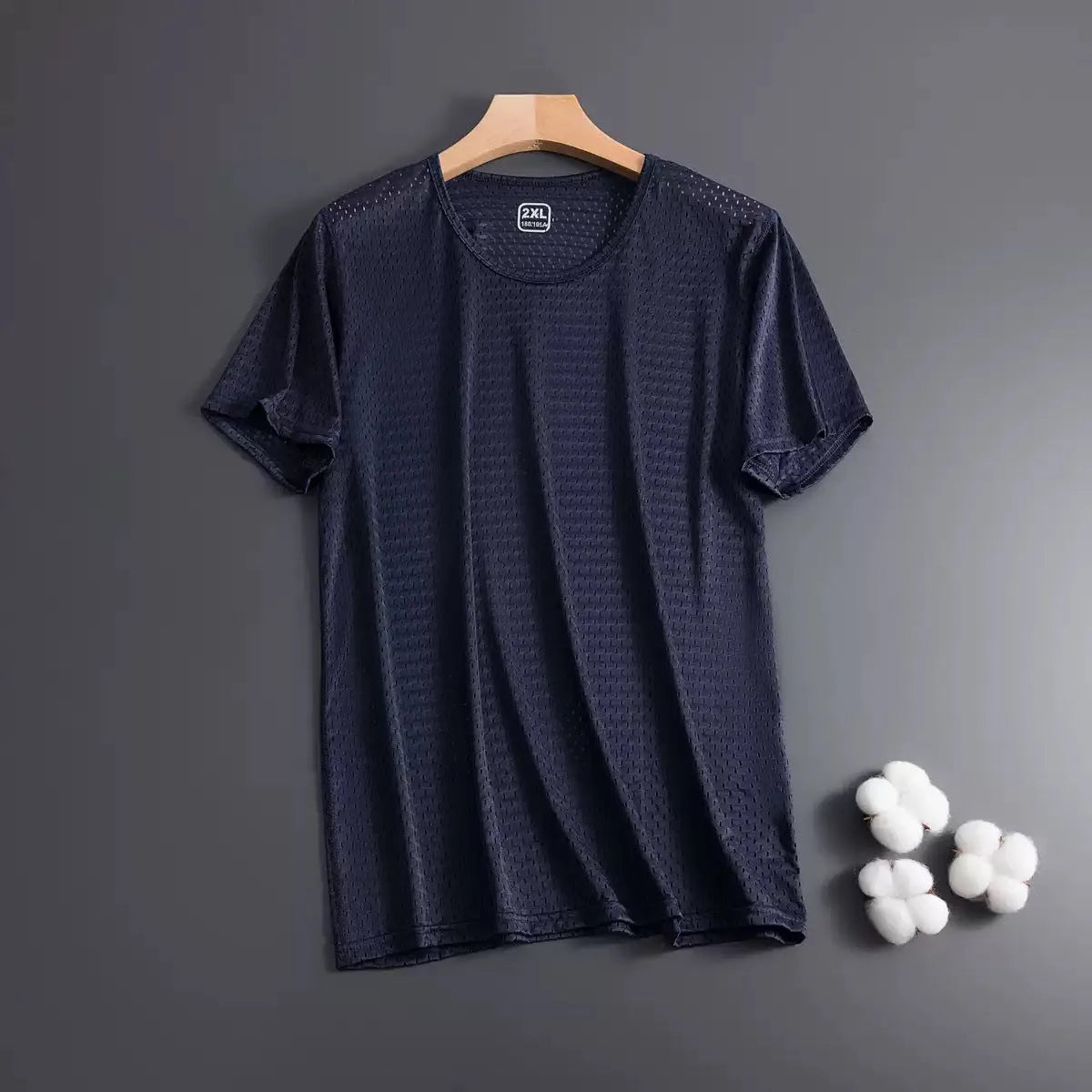 Man wearing a solid colour ice silk short sleeve crew neck T-shirt in a loose fit.