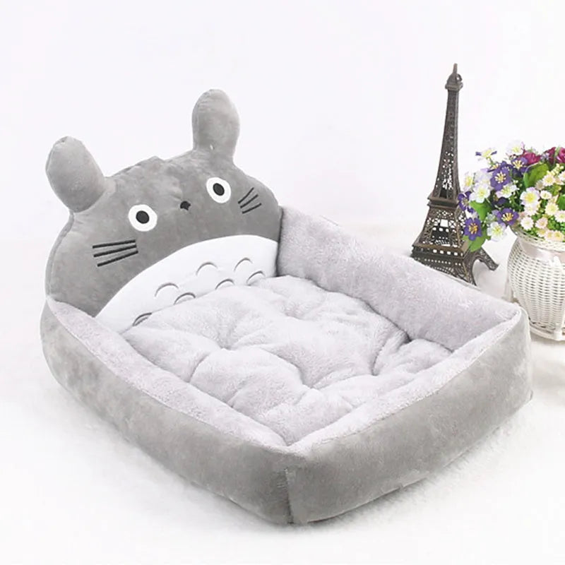 Cartoon-style plush pet sofa bed with a raised rim for a small dog or cat, shown in a blue colour