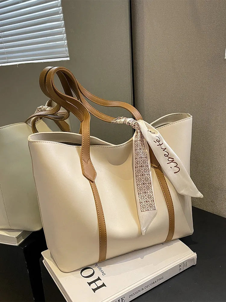 Large capacity bucket style tote bag with crossbody strap in multiple colour options