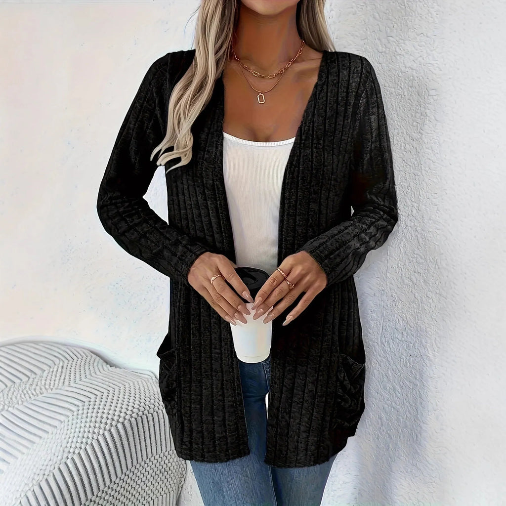 A solid colour long sleeve cardigan with pockets, shown in loose fit on a model.
