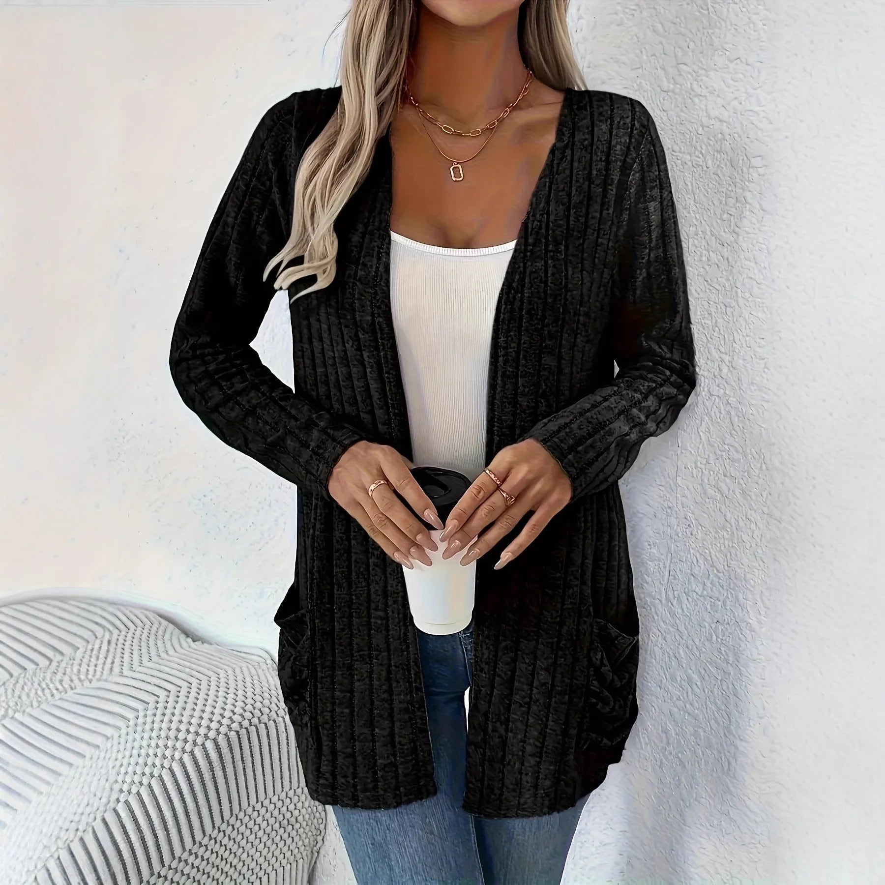 A solid colour long sleeve cardigan with pockets, shown in loose fit on a model.