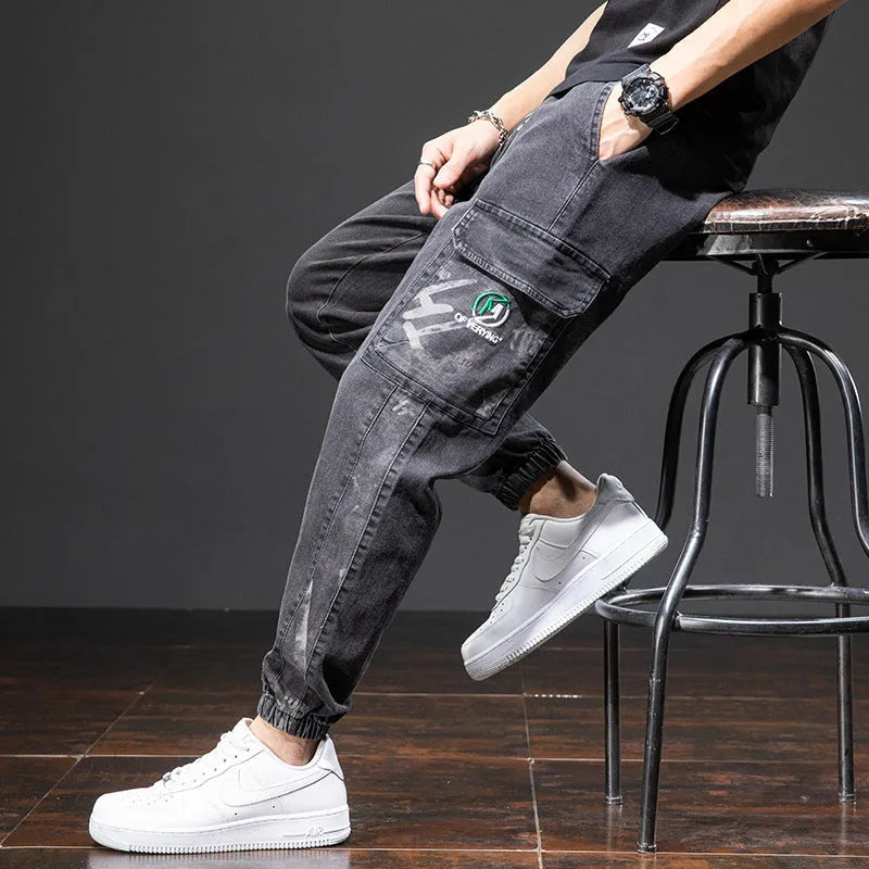 Men's loose blue cargo jeans with straight leg on a neutral background.