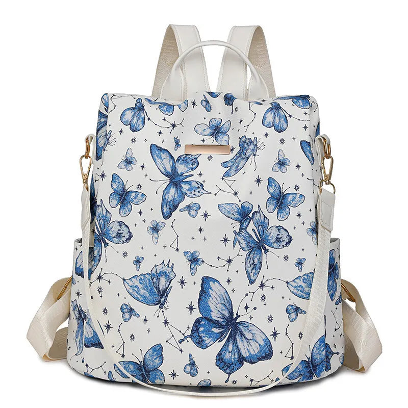 Butterfly print PU leather backpack in purple shown from the side, featuring sewing line details and shoulder straps.