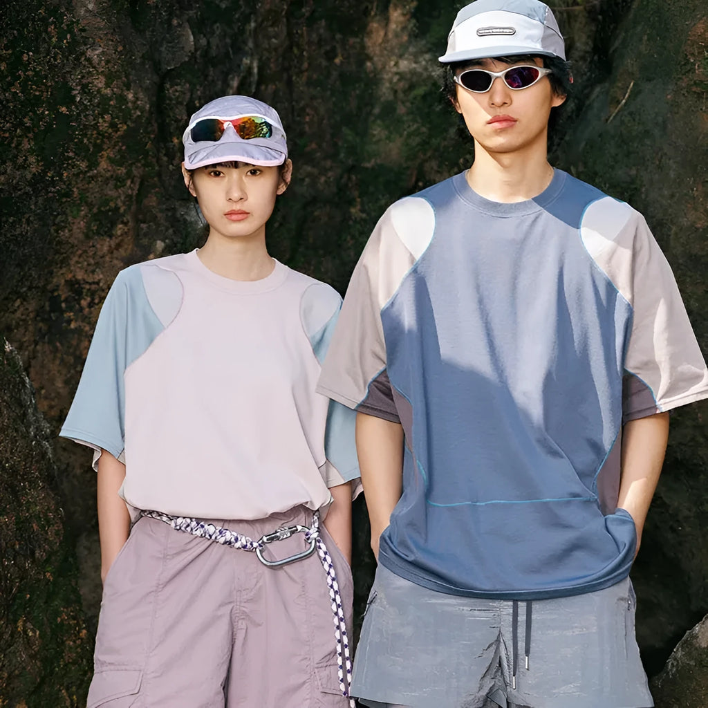 Men's loose blue patchwork t-shirt with raglan short sleeves on a white background.