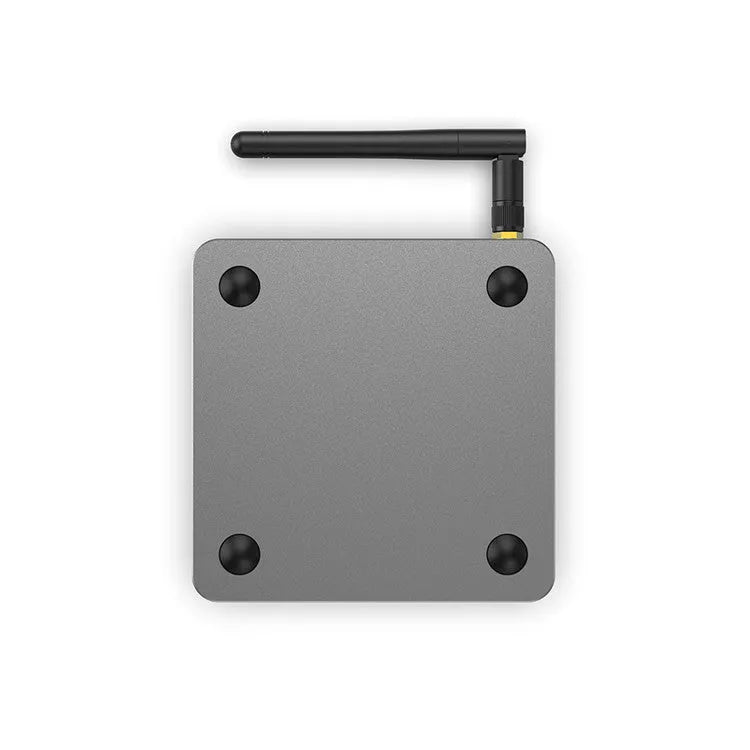 Android Smart Voice Set-top Box with remote control, HDMI cable, and power adapter on a table.