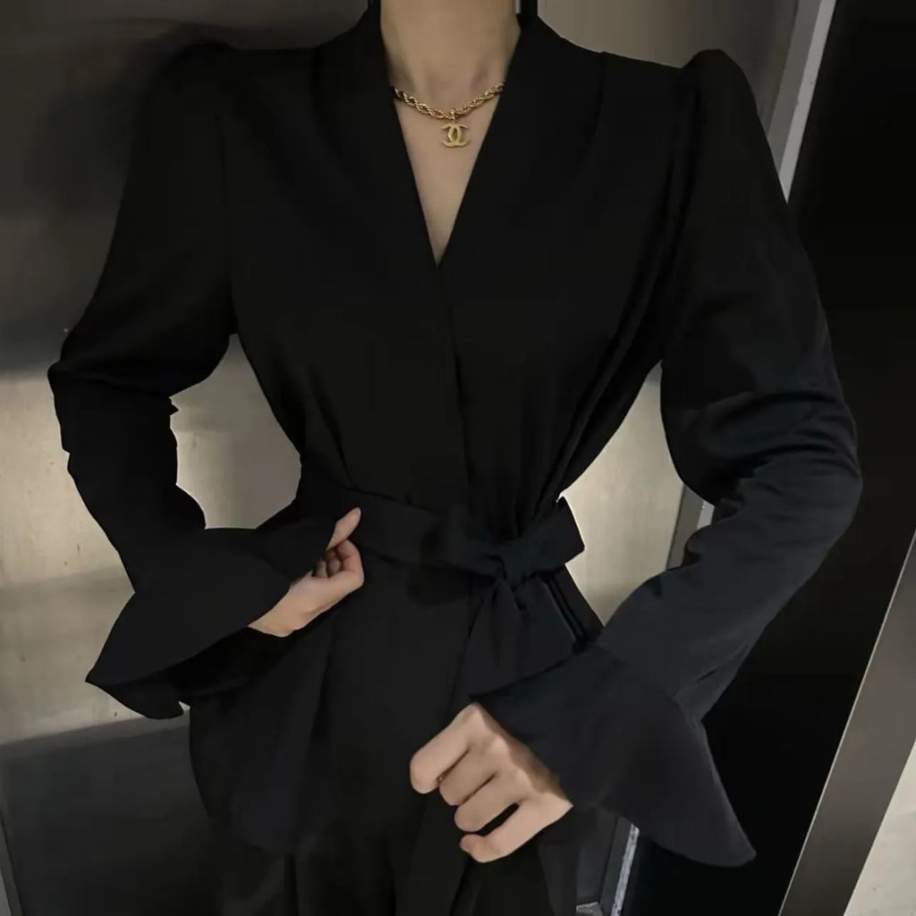Women's black French-style shirt with irregular collar and long tied bell sleeves.