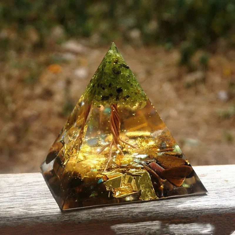 A clear 6cm tall epoxy resin pyramid hanging ornament for displaying crystals.