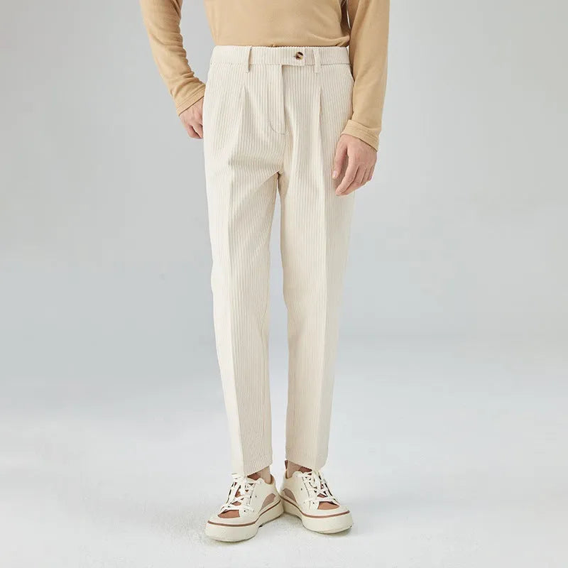 Men's straight-leg corduroy trousers in beige on a hanger, showing the textured fabric and mid-waist design.