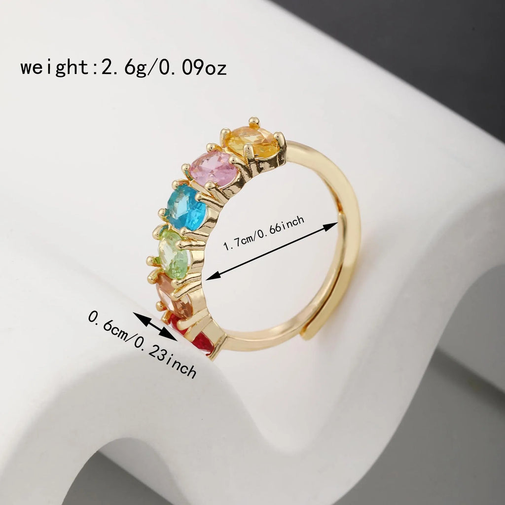 Gold-coloured adjustable zircon ring with simple retro design on a white background