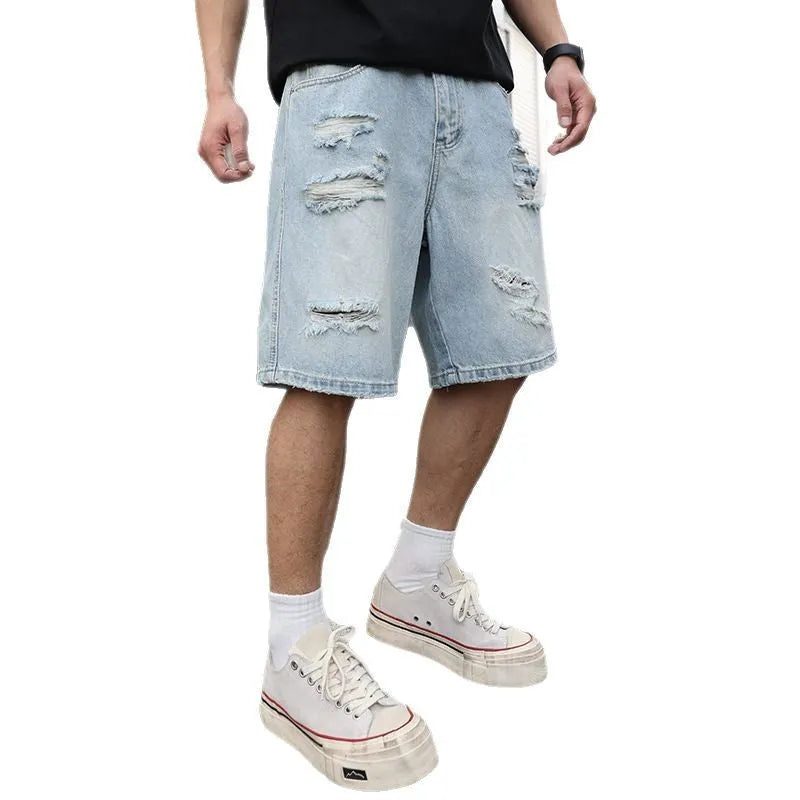Light blue ripped denim shorts with a distressed wash and loose straight-leg fit on a model.