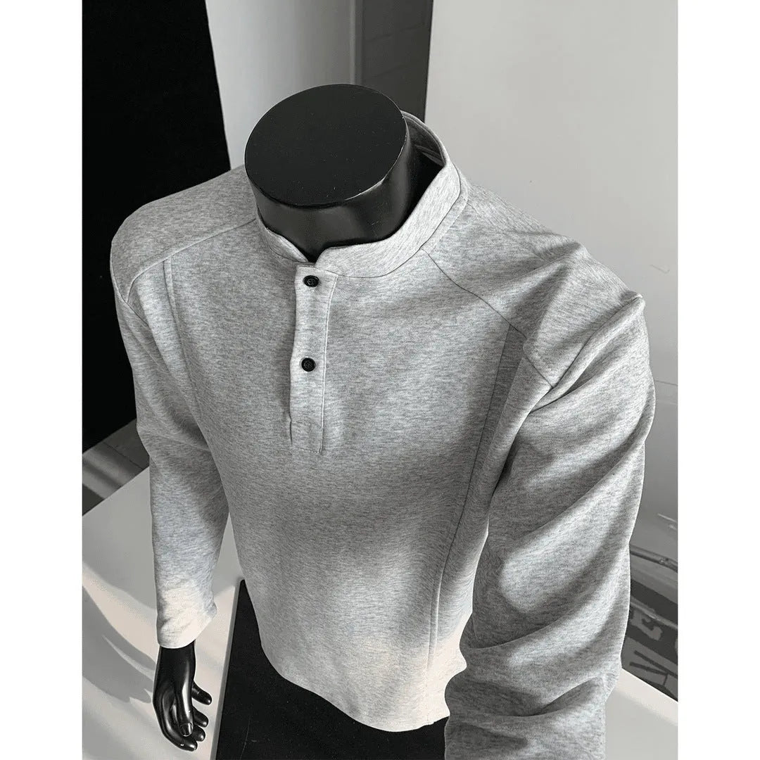 Men's black asymmetric patchwork long sleeve polo shirt with a stand-up collar, laid flat.