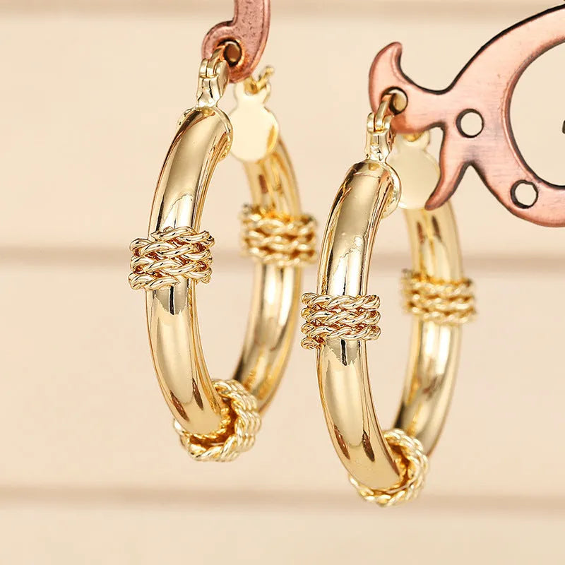 Geometric women's copper earrings with ring and line elements in golden colour