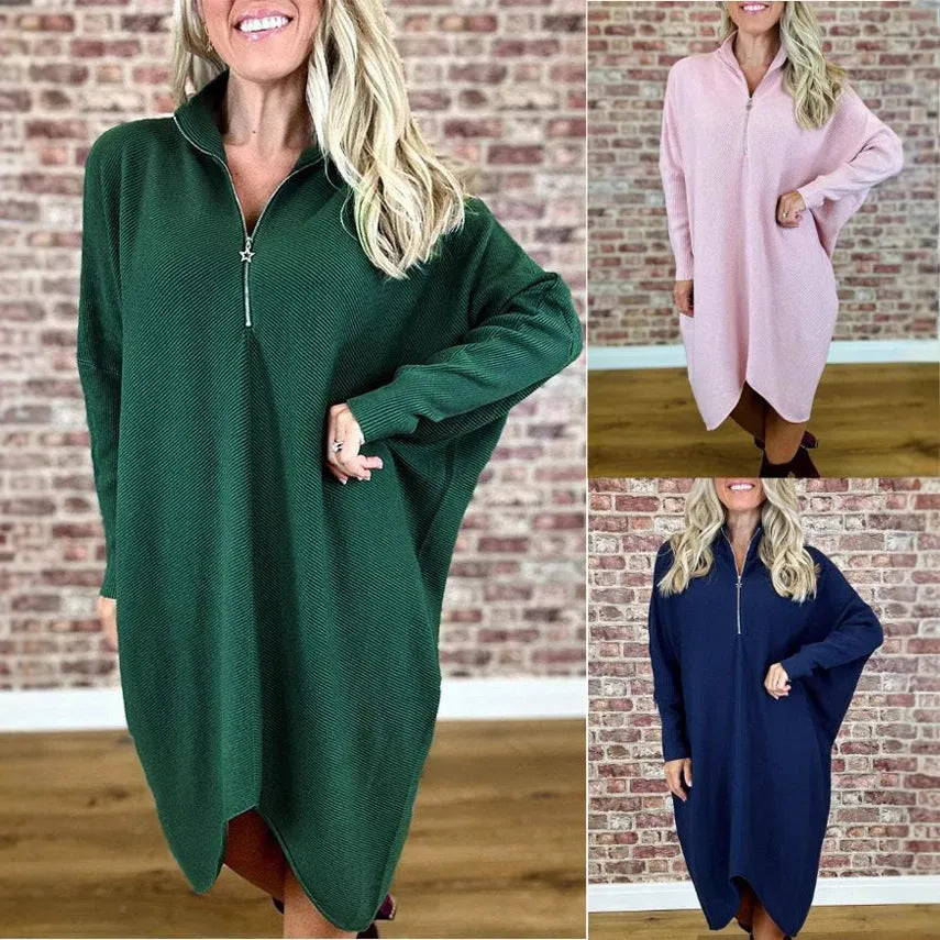 A women's solid colour loose knitted dress with raglan sleeves and a front zipper.