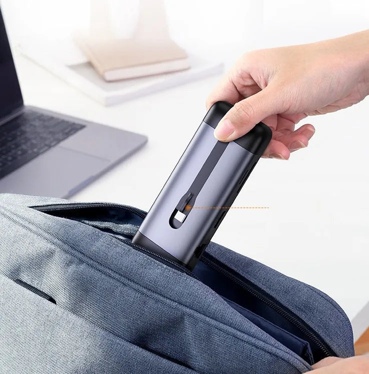 USB-C expansion dock adapter with short cable, showing HDMI, USB 3.0, and Power Delivery ports.