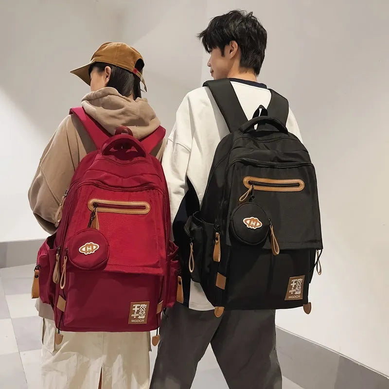 Large-capacity nylon backpack for middle school students in blue colour with curved shoulder straps.