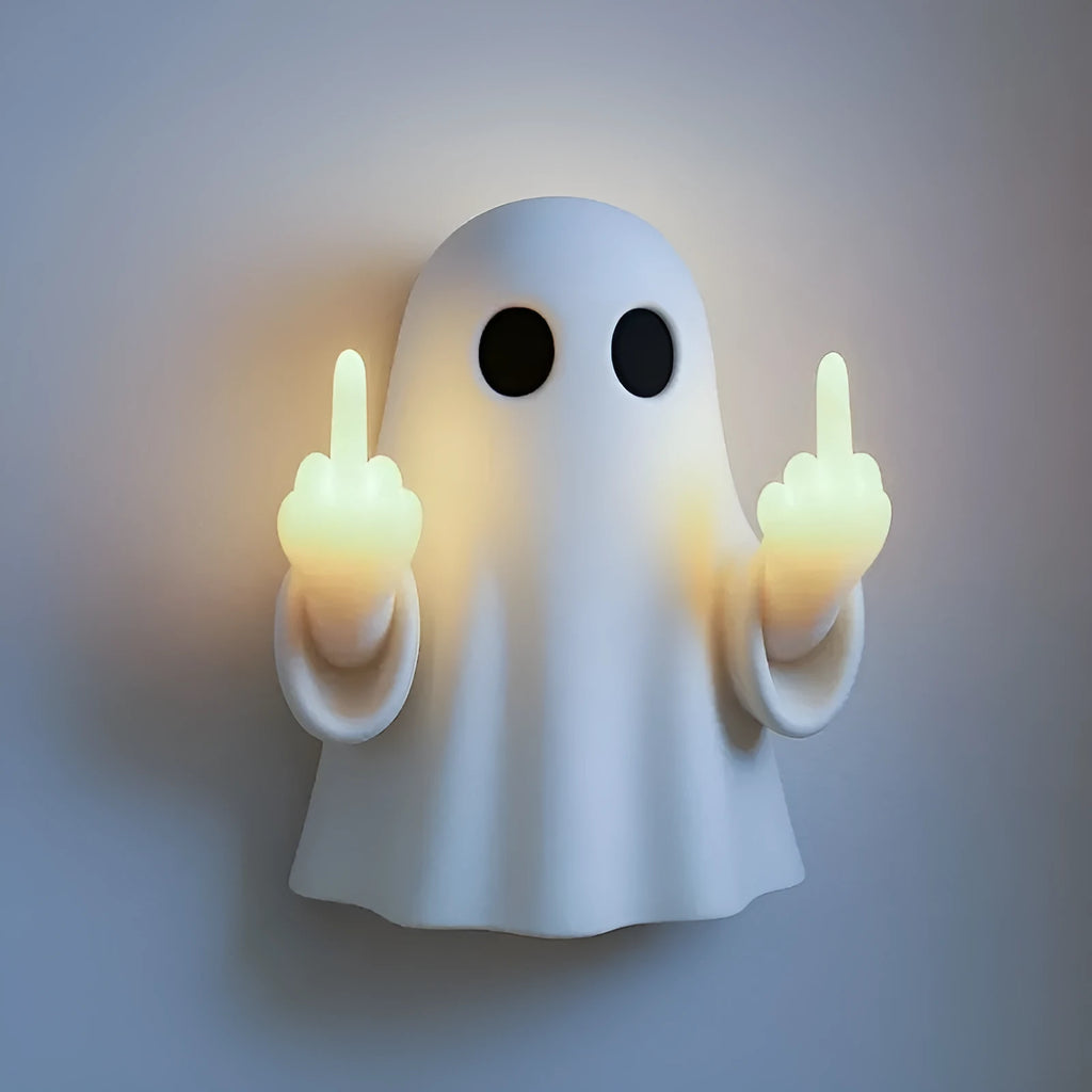 Small white ghost statue night lamp on a shelf for Halloween decor.