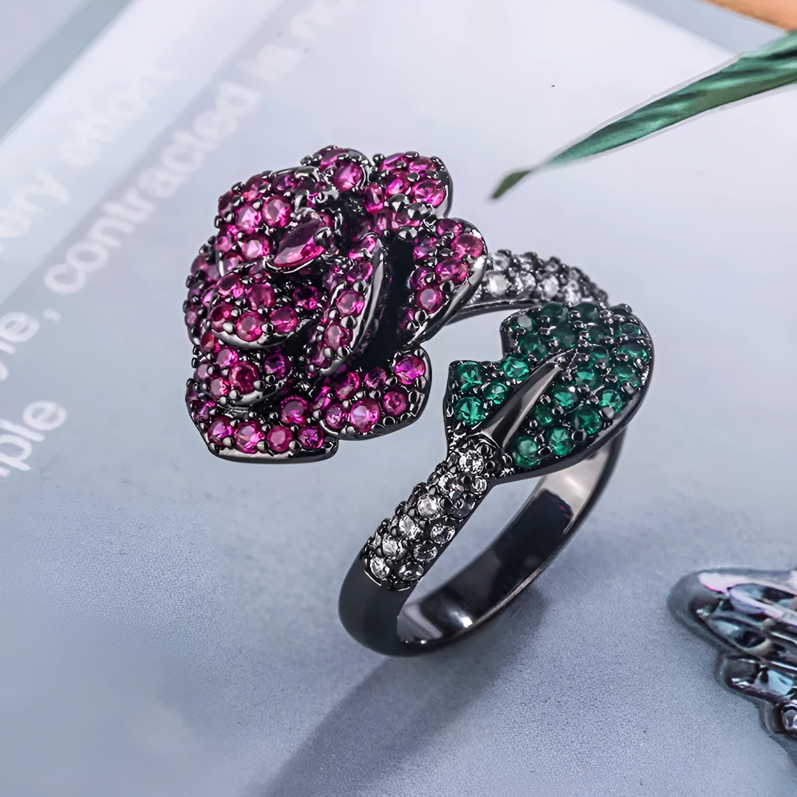 Gold-plated copper ring with geometric flower design and simulation red corundum in black gold finish
