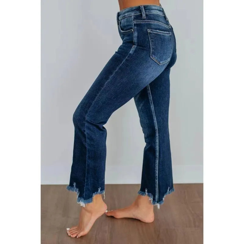 Women's solid dark blue denim casual pants with a hand-worn finish on a hanger.