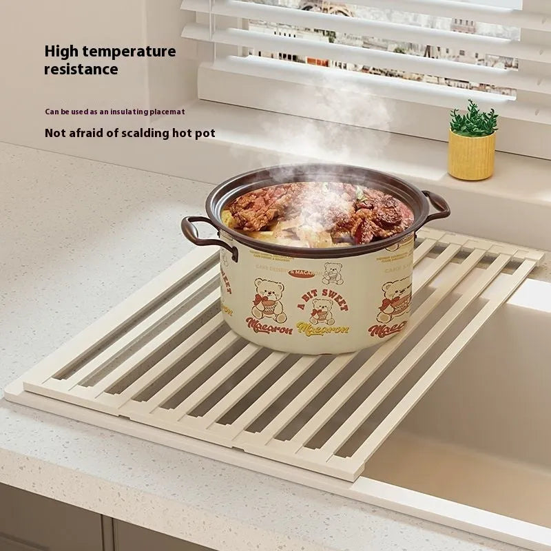 Foldable milky white stainless steel kitchen draining rack shown open and folded, next to a sink.