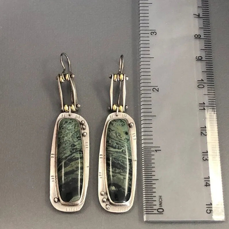 A pair of geometric-shaped fashion earrings with a two-colour marble pattern, made from alloy metal.