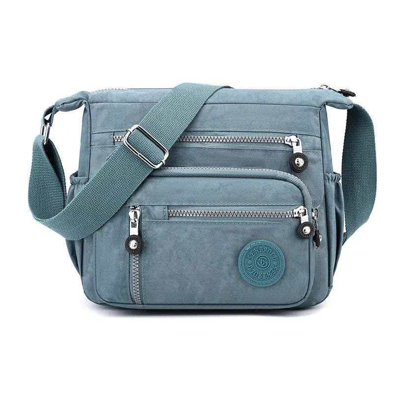 Grey square vertical nylon messenger bag with a single shoulder strap shown open.