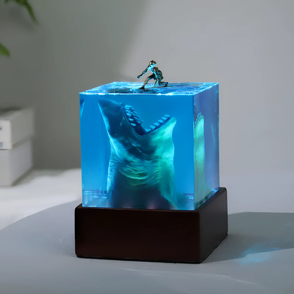 Clear epoxy resin shark surfer night light ornament with LED base in 5cm and 8cm sizes.