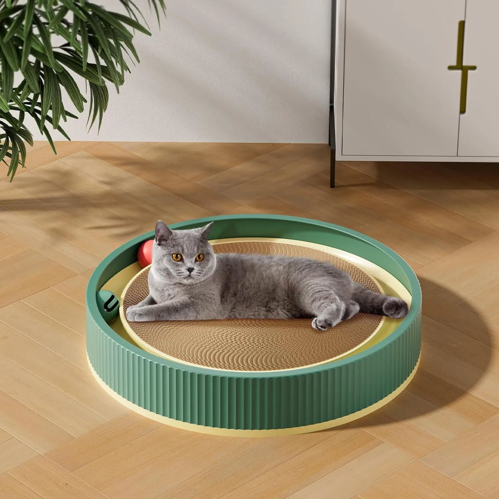 Large green circular cat scratching board with ball track and plush ball toy in the centre.
