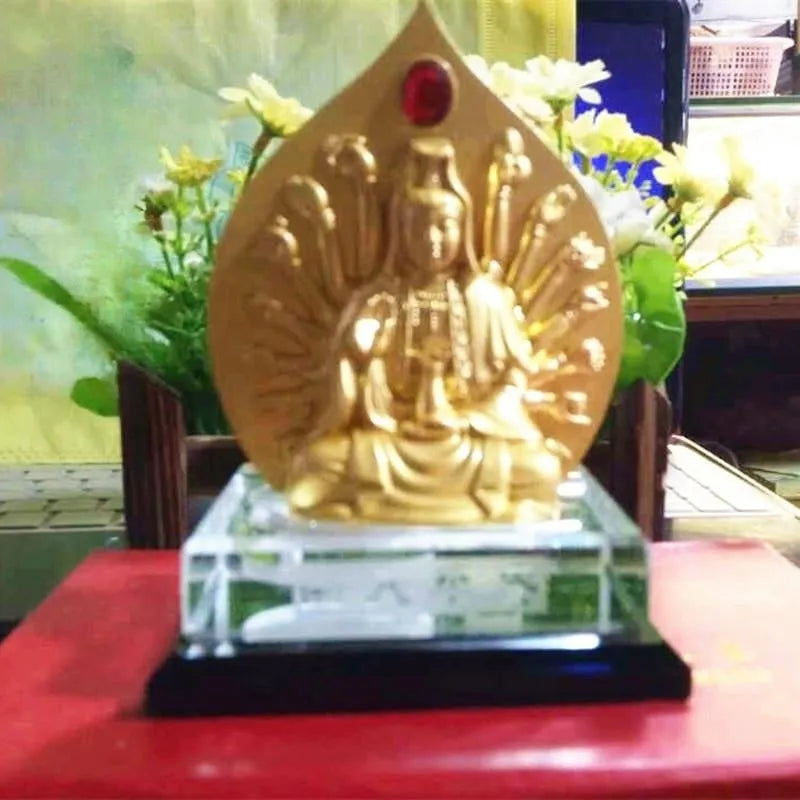 Alloy rotating prayer wheel car decoration in traditional Chinese style on a car dashboard.