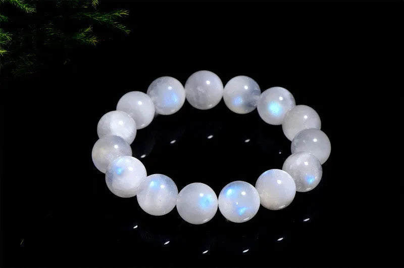 Natural blue moonlight polished round moonstone bead bracelet on a white background.