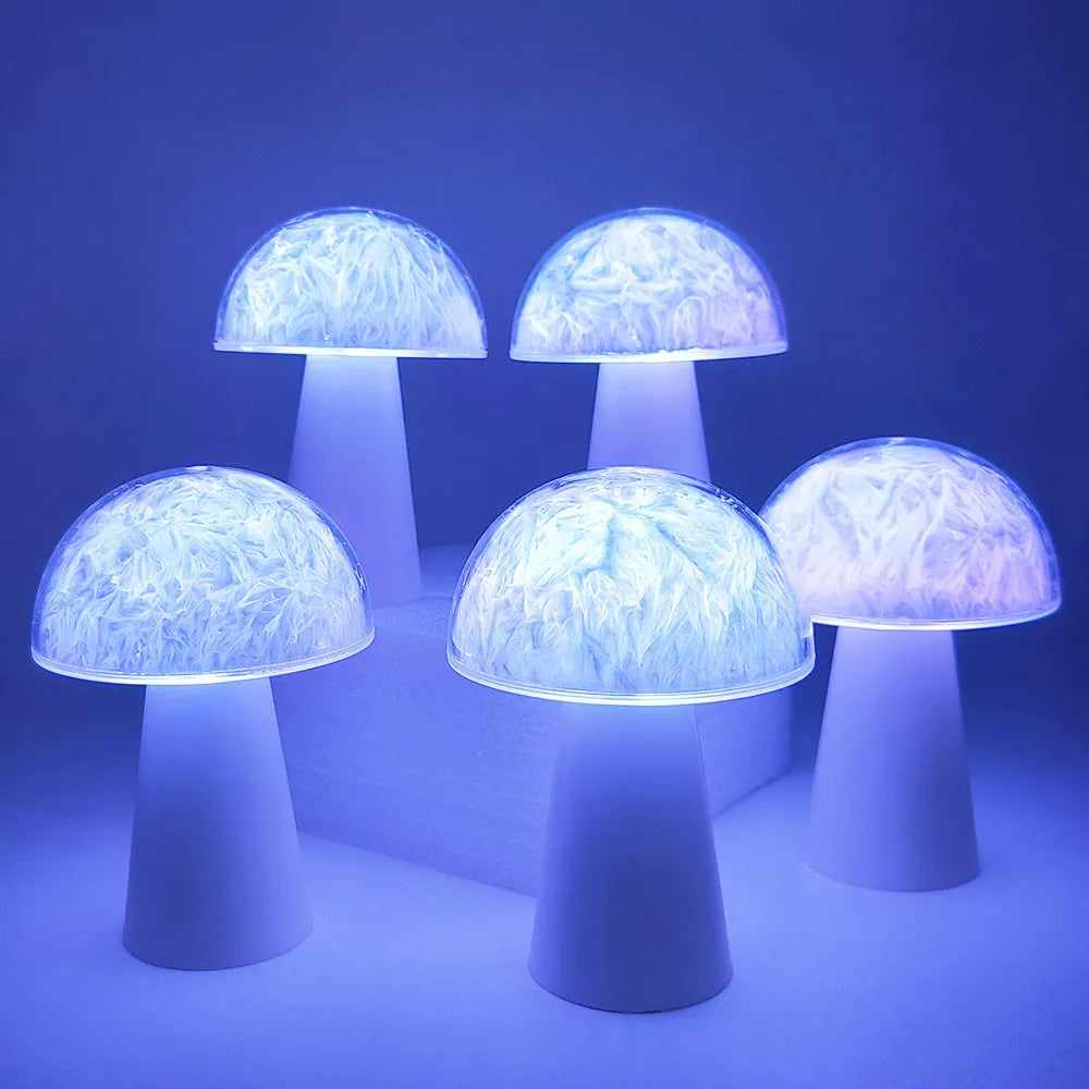 Small white mushroom-shaped night light with remote control on a wooden table.