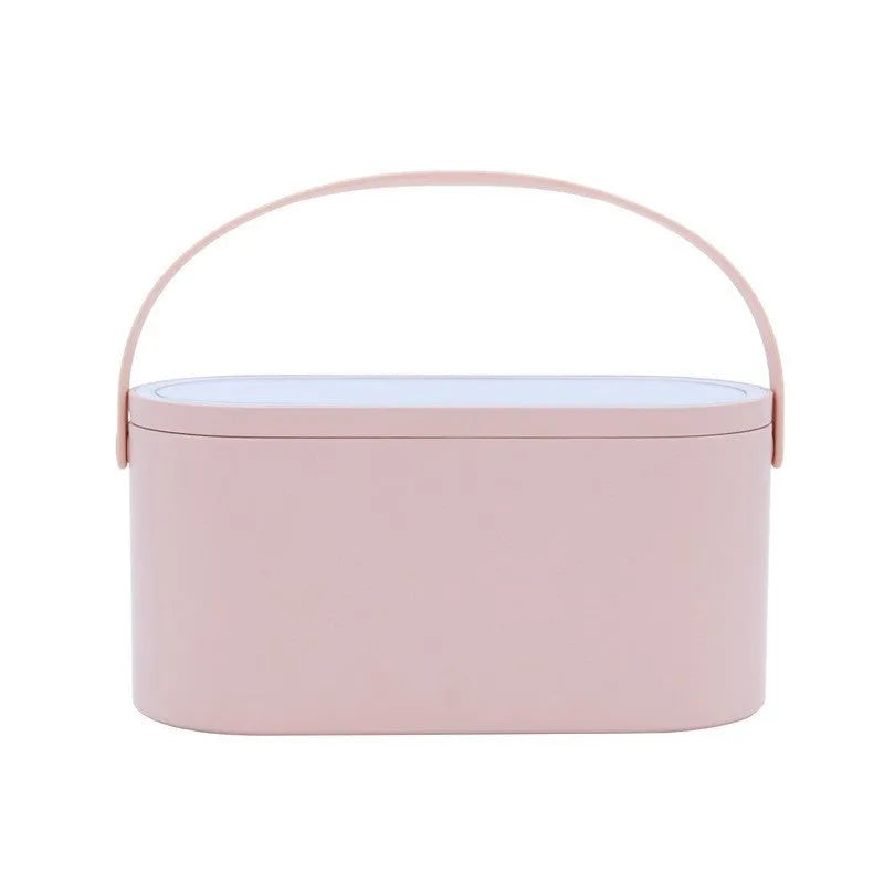 Portable LED light storage box beauty and makeup mirror with aluminium mirror lens in pink colour on a bedroom surface.