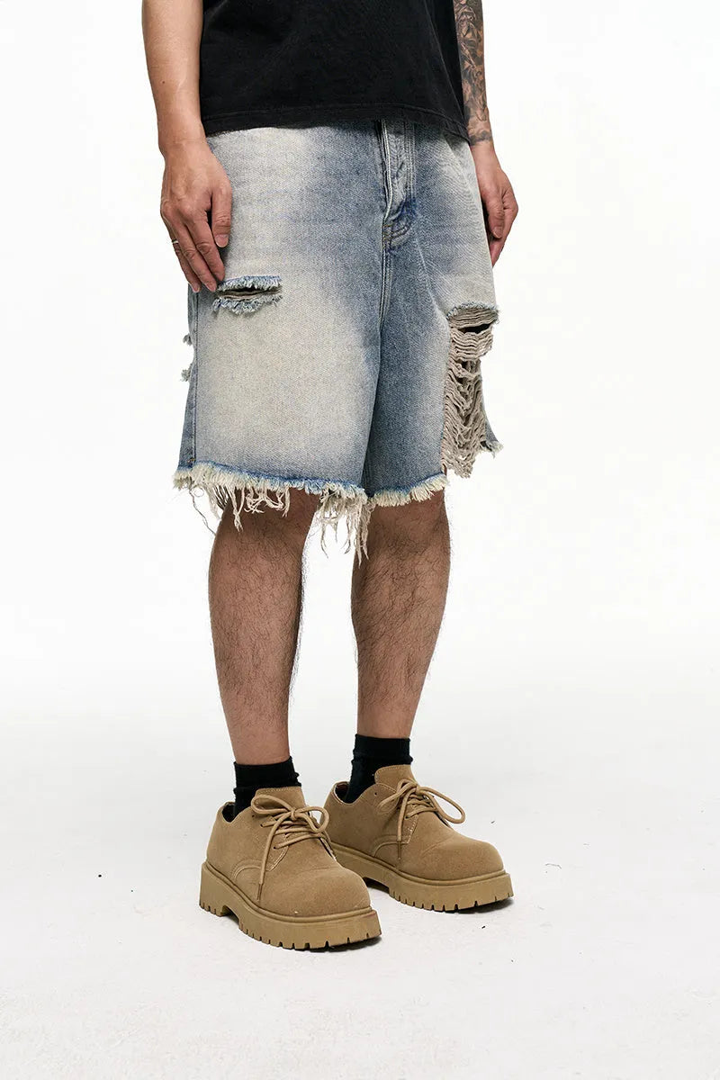 Light blue washed denim shorts with baggy wide leg cut and zipper fly