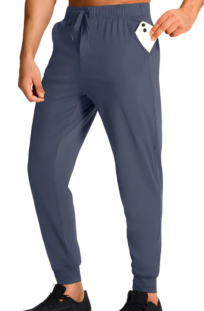 Men's solid colour loose fit casual trousers in polyester fabric on a hanger.