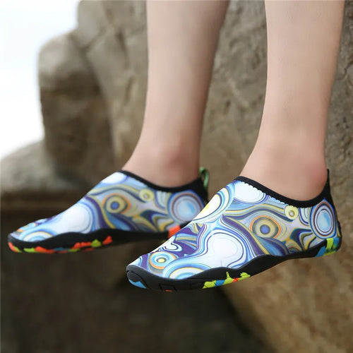 Men's and women's beach wading shoes in blue, with Lycra upper and EVA midsole, on a sandy background.
