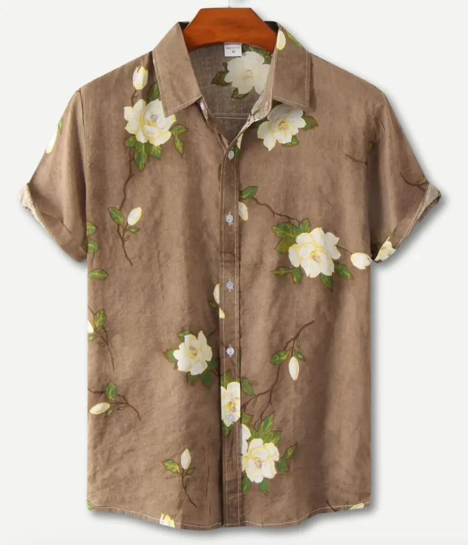 Man wearing a short sleeve Hawaiian shirt with a blue and white floral digital print and a lapel collar.