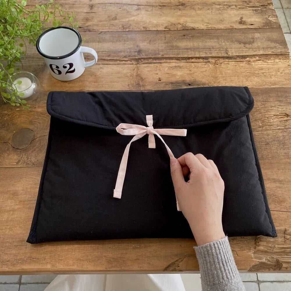 Women's black and white striped quilted computer bag with ballet bow design for laptops