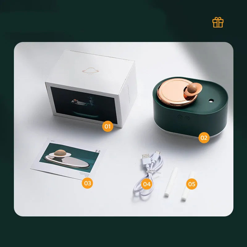 Green rotating planet-shaped USB humidifier with night light on a wooden desk