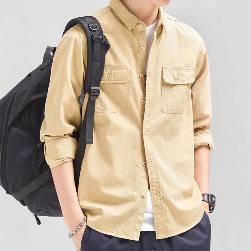 Man wearing a loose fit long sleeve cardigan shirt in light grey polyester.