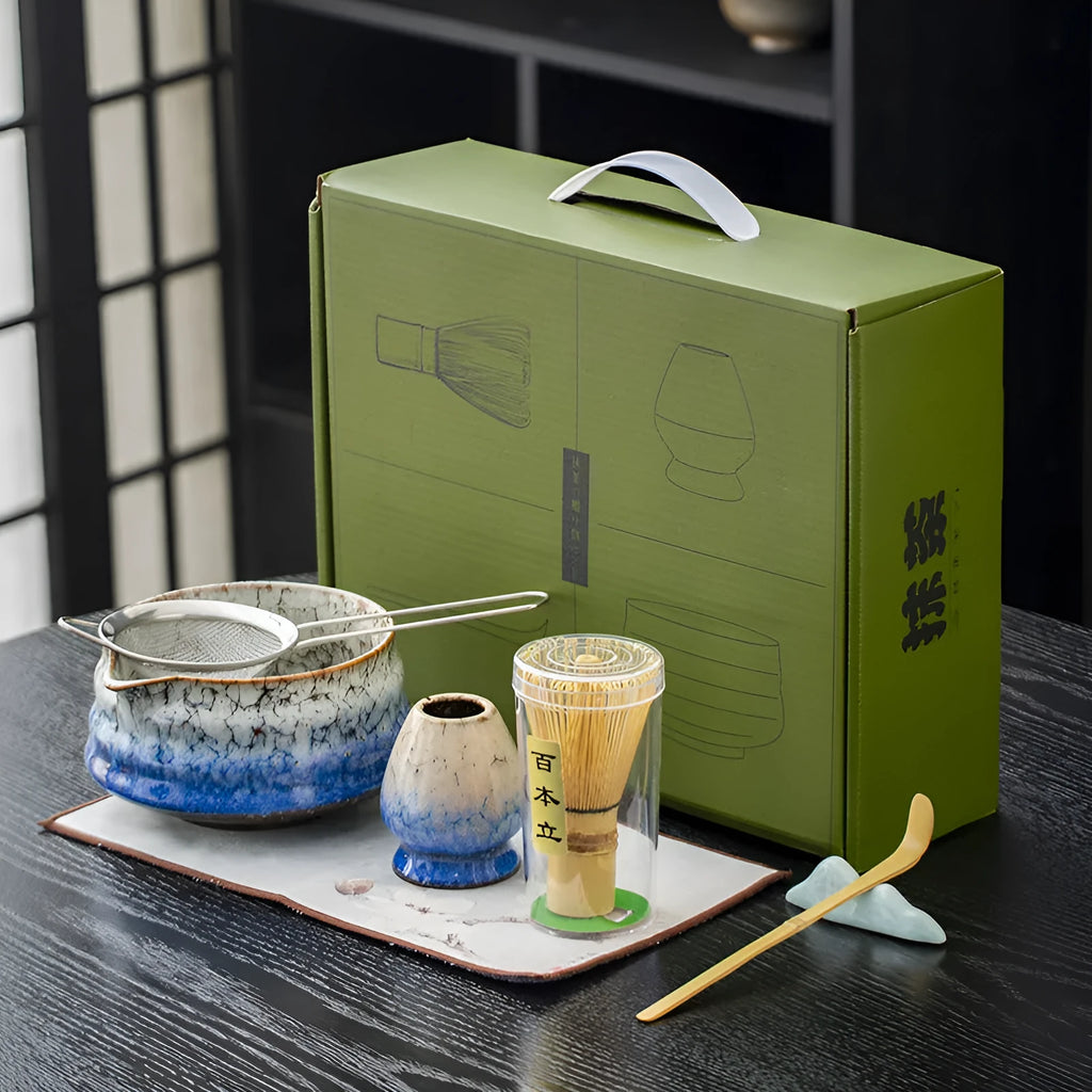 Seven-piece Japanese style matcha set with ceramic bowl, bamboo whisk, stand, tea tray, filter screen, and tea towel in gift box
