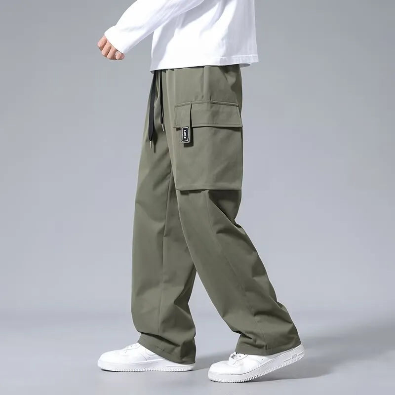 Boys straight leg cargo pants in army green with large pockets and a drawstring waist.