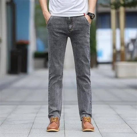 Man wearing smoky grey straight leg jeans with low waist and zipper fly.