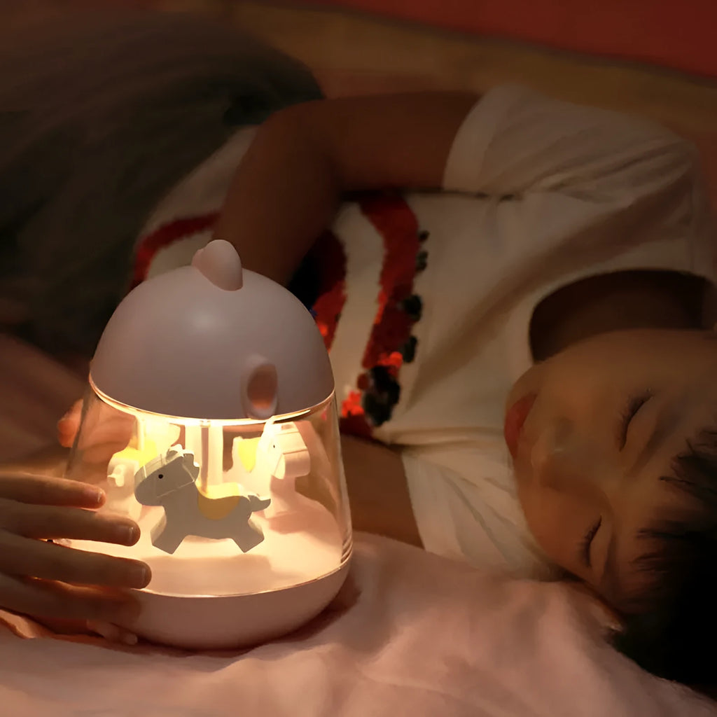 USB carousel music light with rotating trojan, music box, and warm yellow light on a desk.