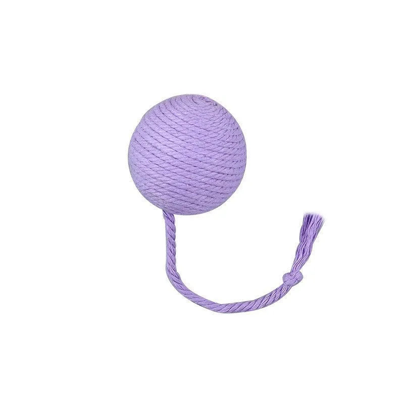 Green cat toy ball with attached rope and internal bell next to a pink one.